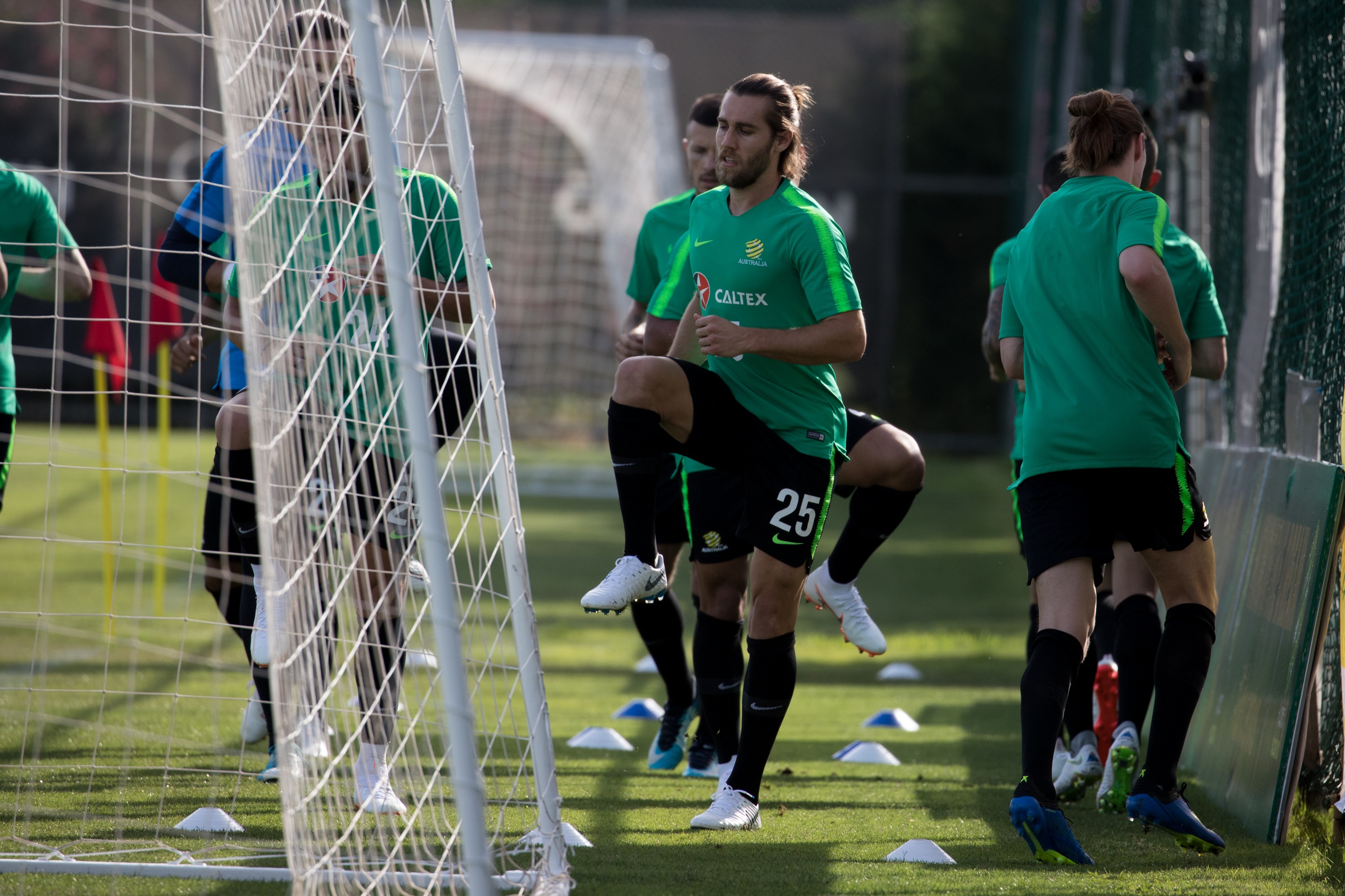 Socceroos players warm up