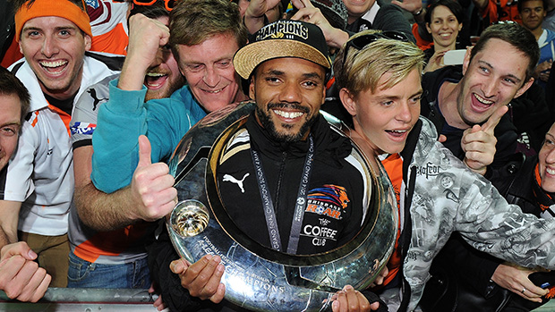 Brisbane Roar's Henrique parades the Hyundai A-League trophy in front of fans.