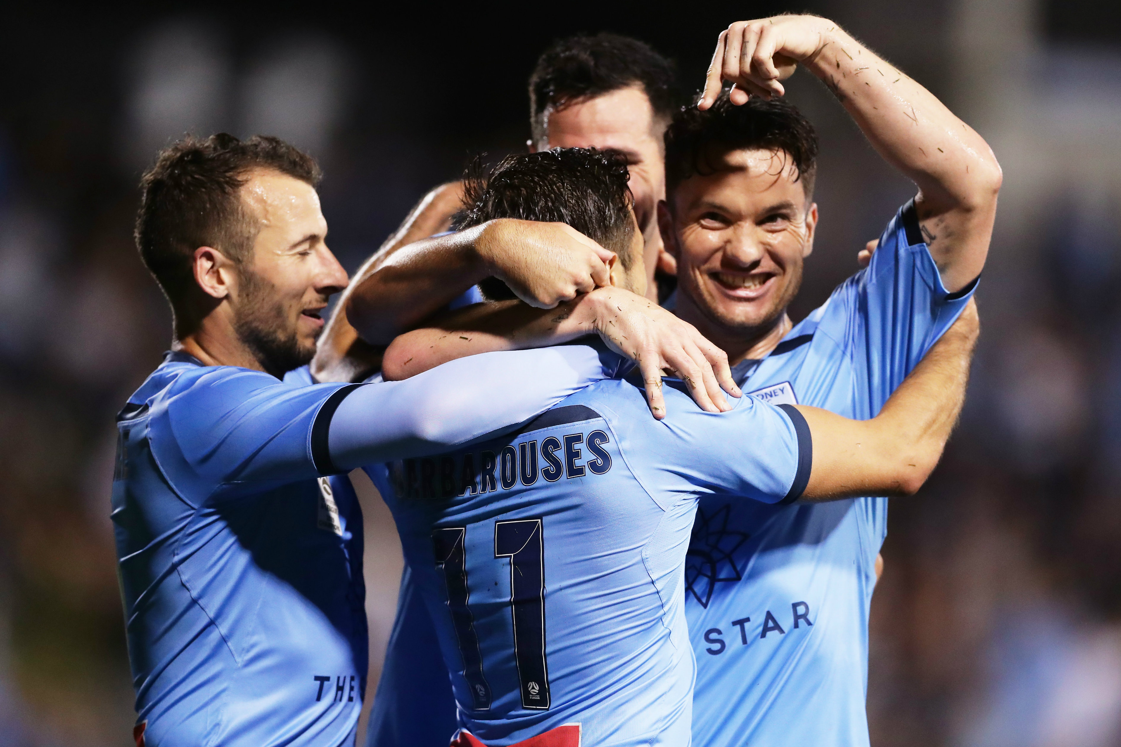 Sydney FC players celebrate with Barbarouses after his goal
