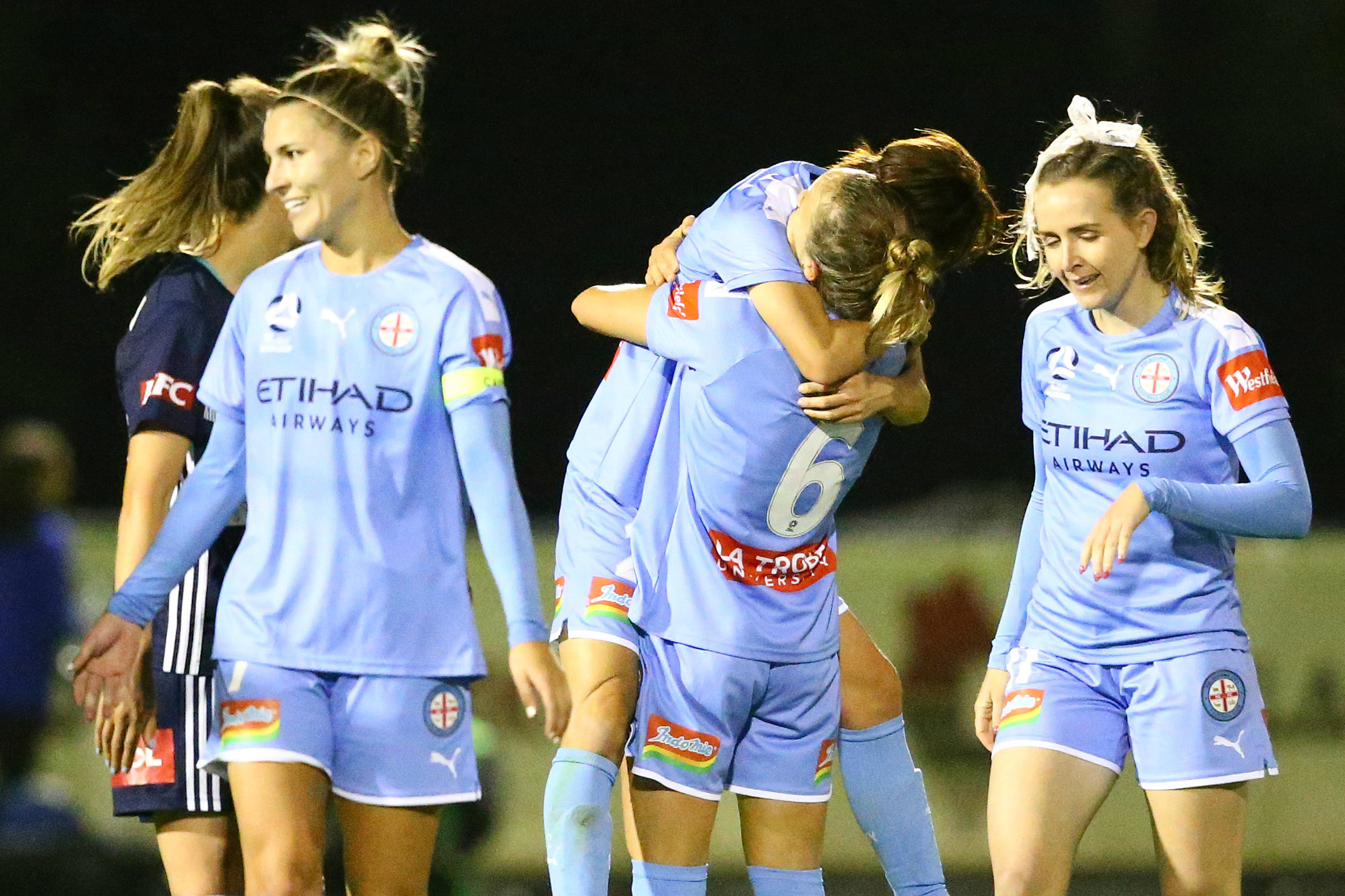Yukari Kinga and Aivi Luik embrace after last week's win over Melbourne Victory
