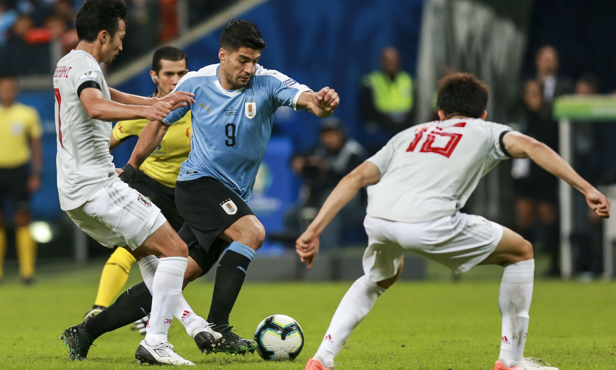 Uruguay's Luis Suarez takes on Japan's defence in the 2019 Copa America