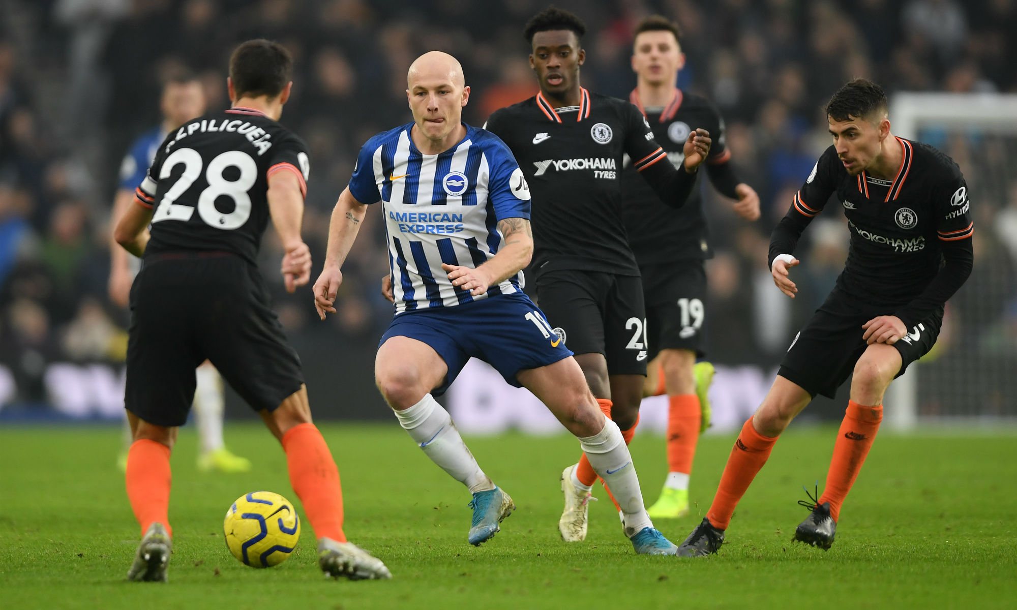 Aaron Mooy is surrounded by Chelsea players as the Caltex Socceroo drives Brighton on at the AMEX Stadium.