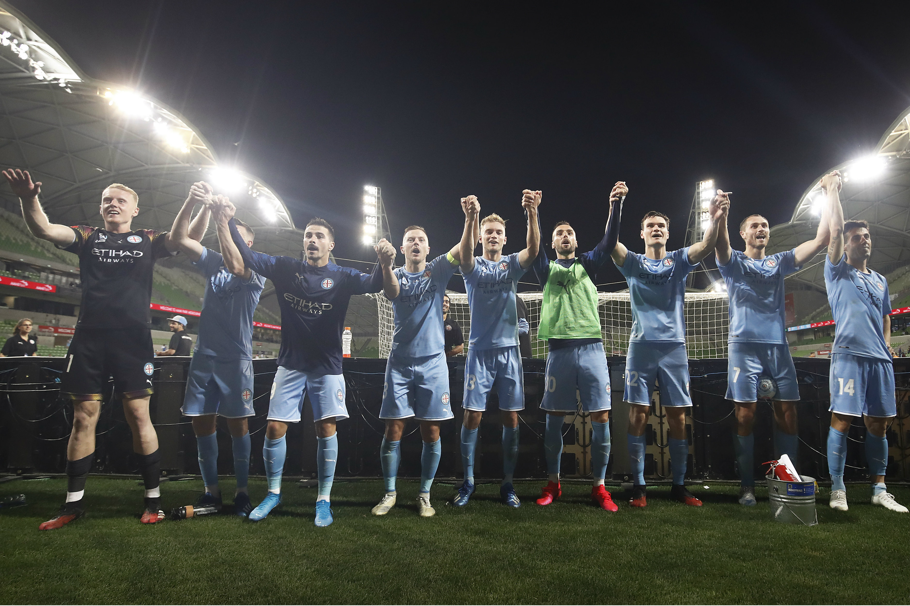 Melbourne City players celebrate in front of the fans