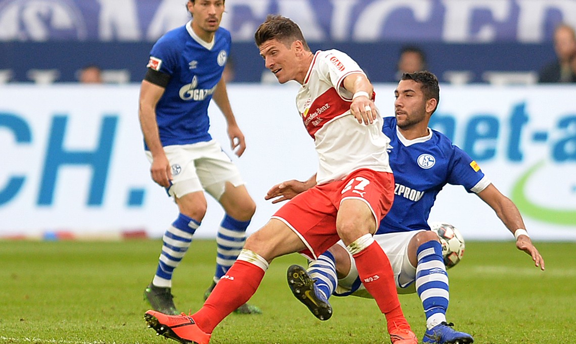 Australian defender George Timotheou tackles Stuttgart and Germany striker Mario Gomez on his Bundesliga debut