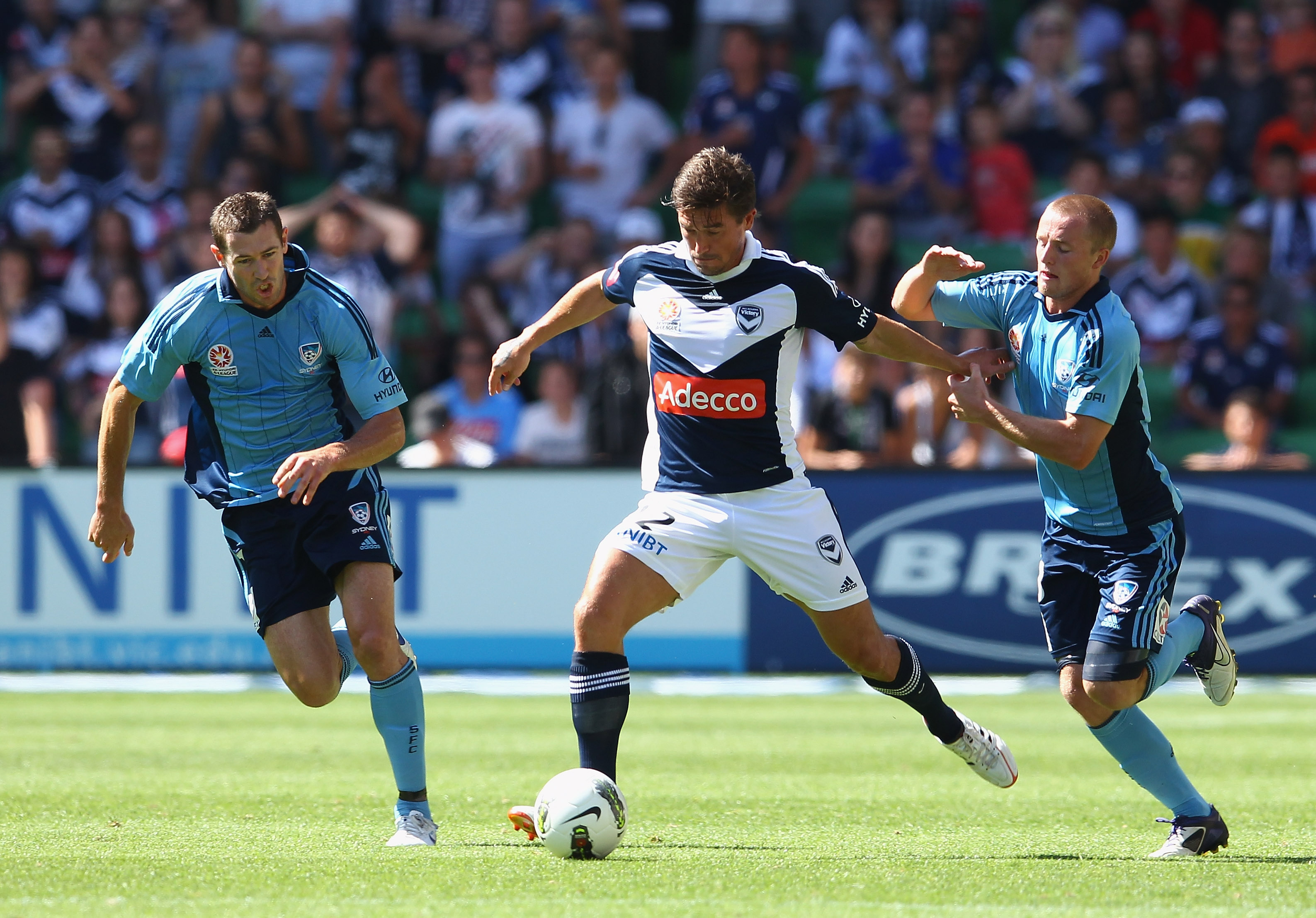 Rhyan Grant challenges Victory's Harry Kewell for the ball in 2012