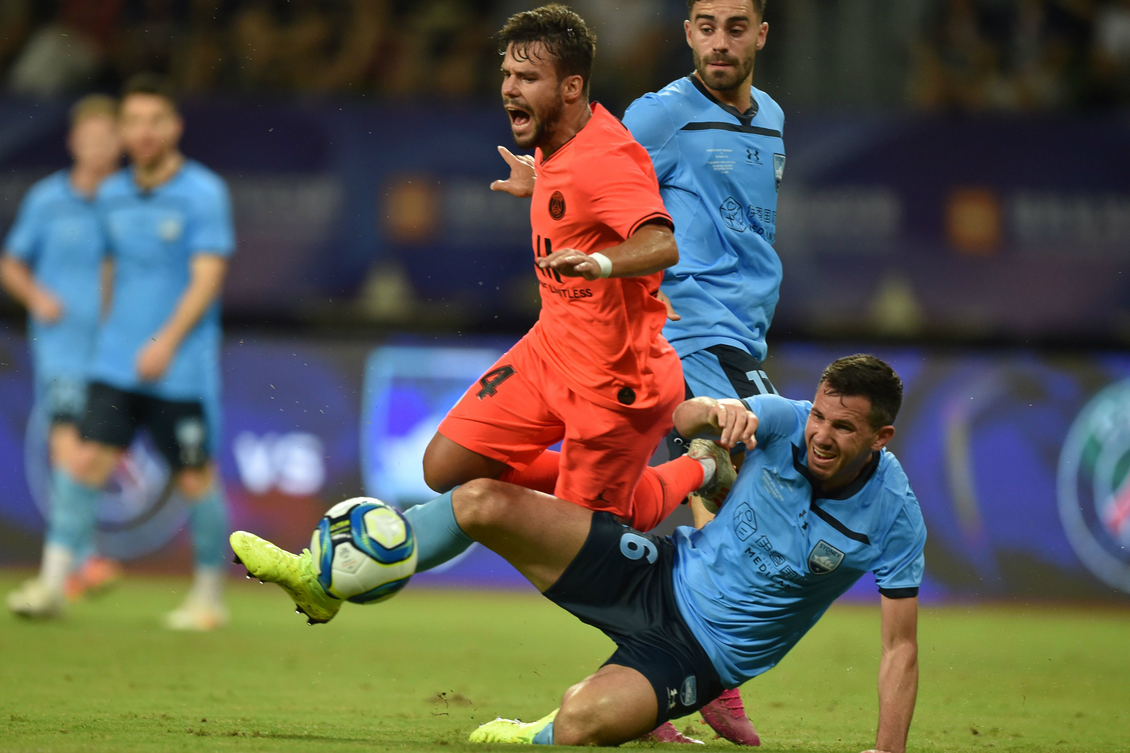 Ryan McGowan wins possession from PSG's Juan Bernat