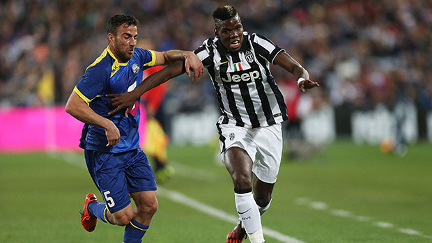 Juventus' Paul Pogba fends off attention from All Star Manny Muscat.