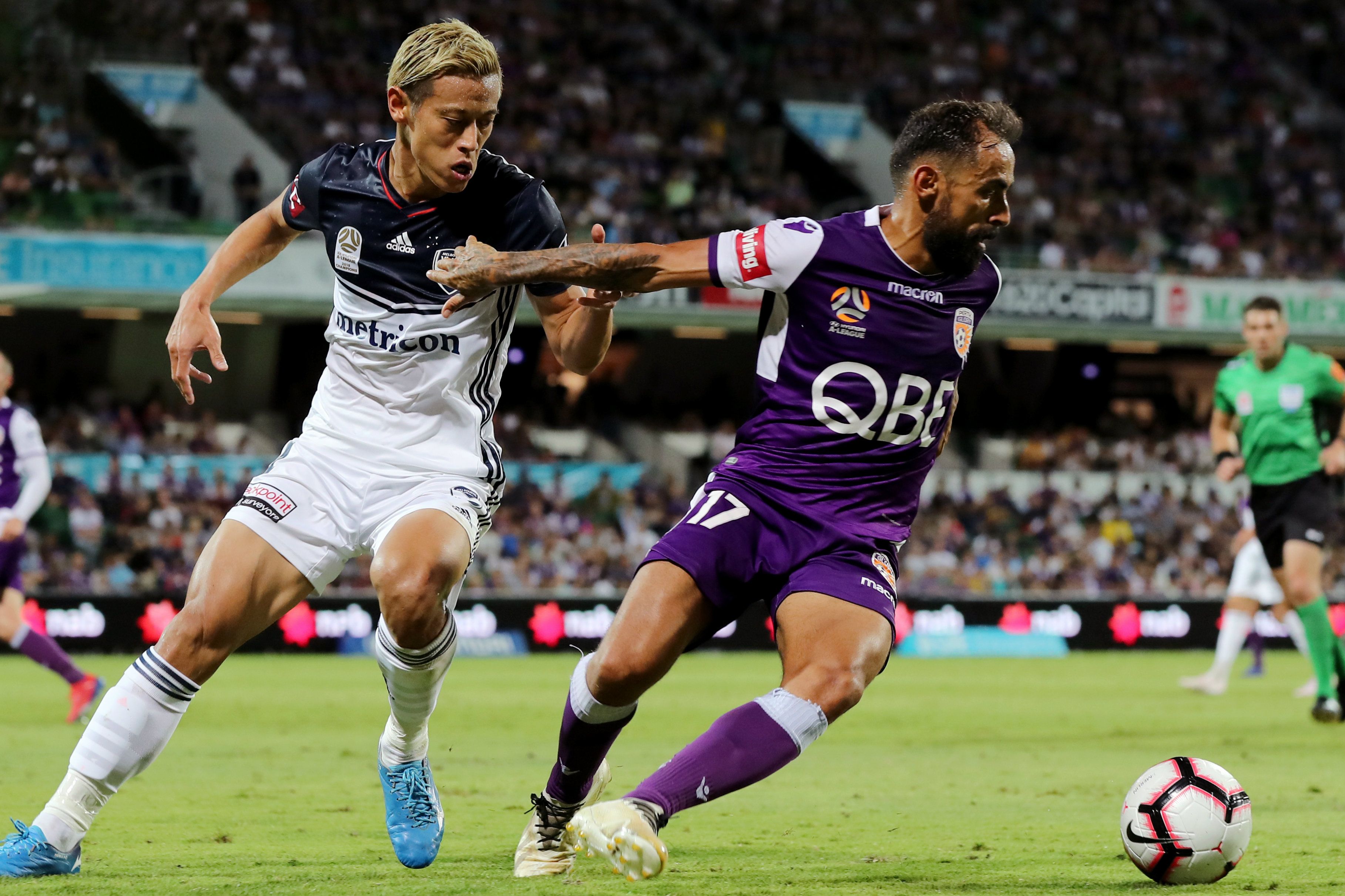 Diego Castro holds off Keisuke Honda at HBF Park