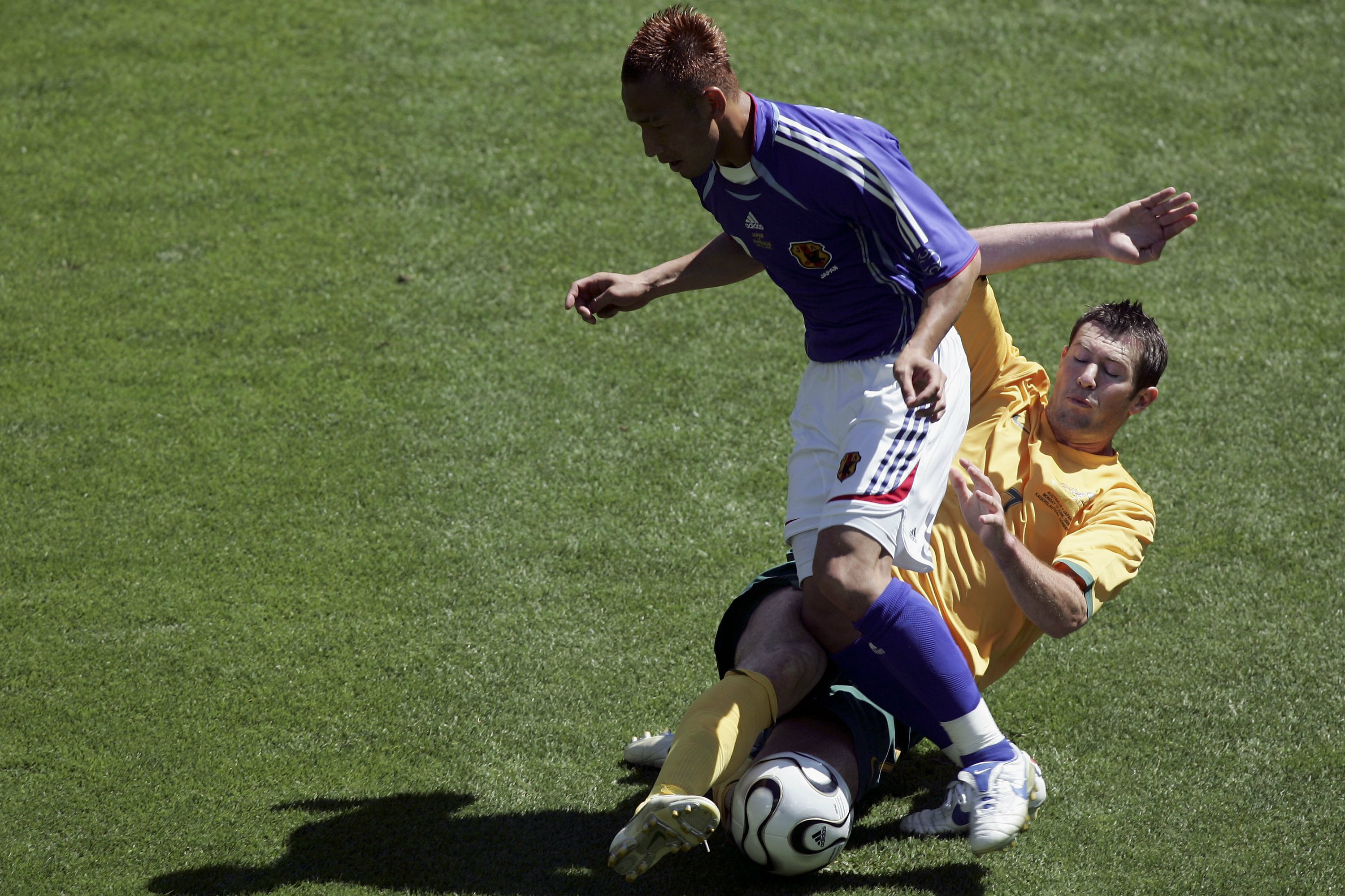 Brett Emerton gets a tackle in against Japan in 2006.