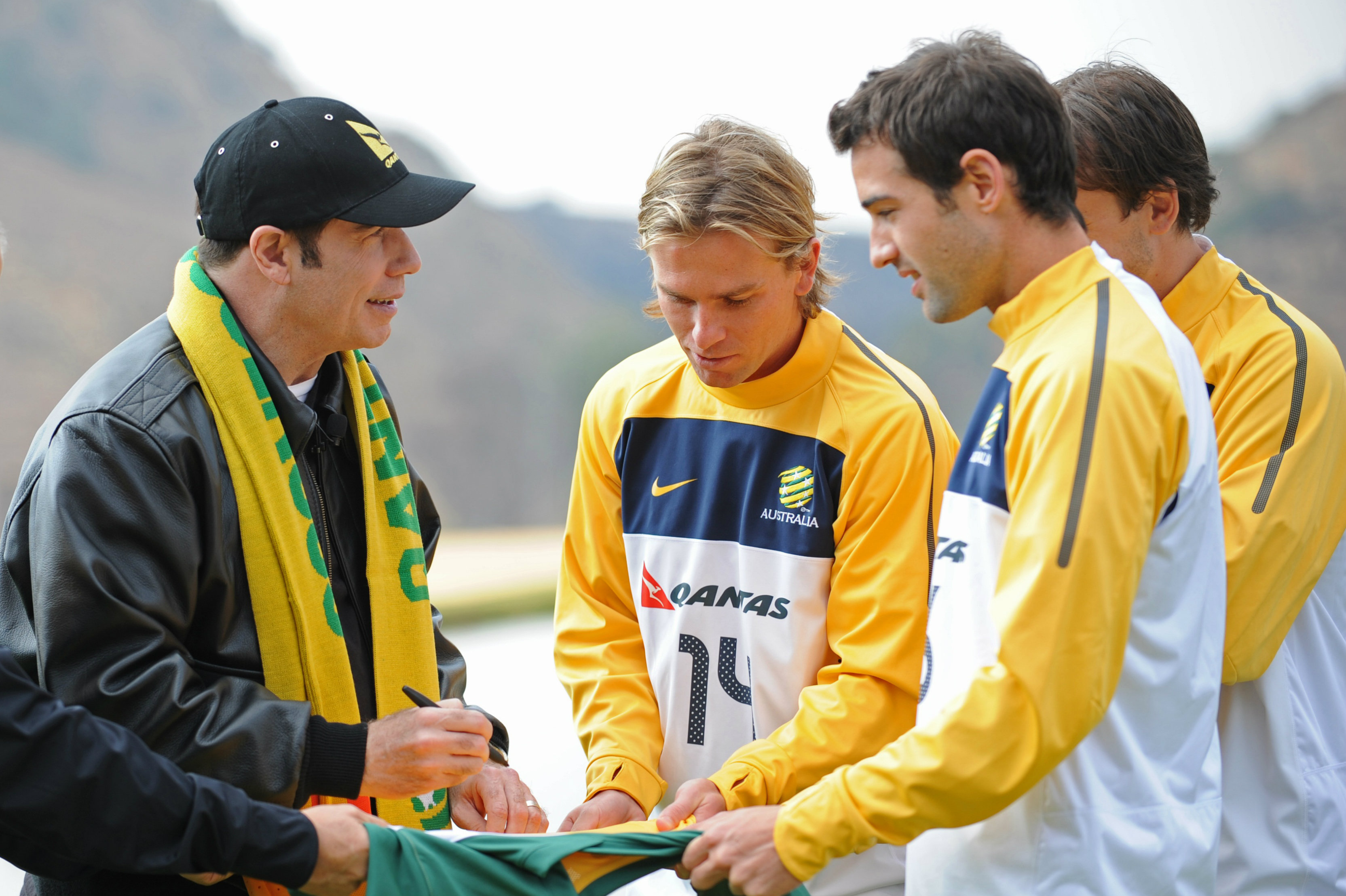 Brett Holman gets his jersey signed by actor John Travolta.