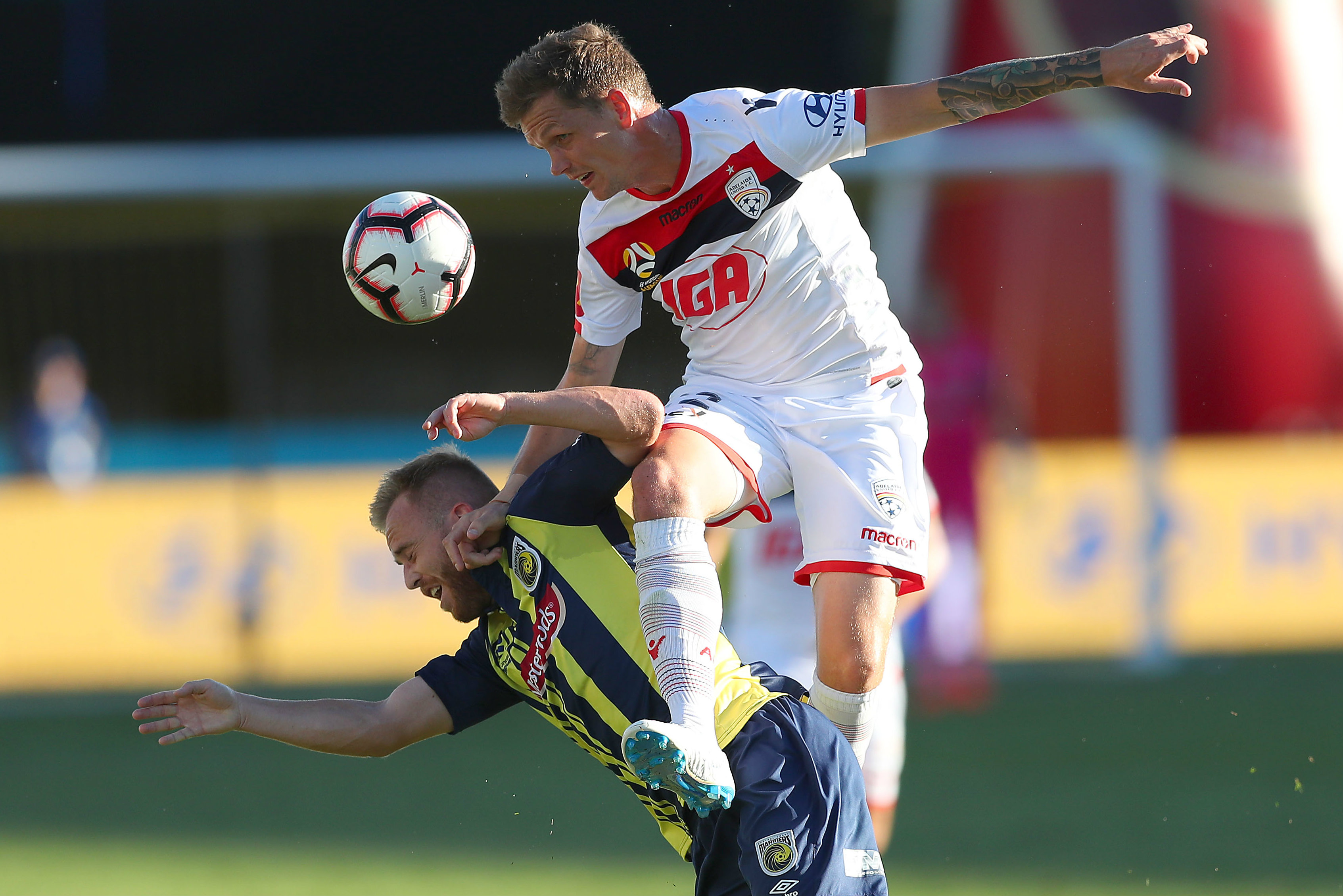 Michael Jakobsen wins a header against the Mariners