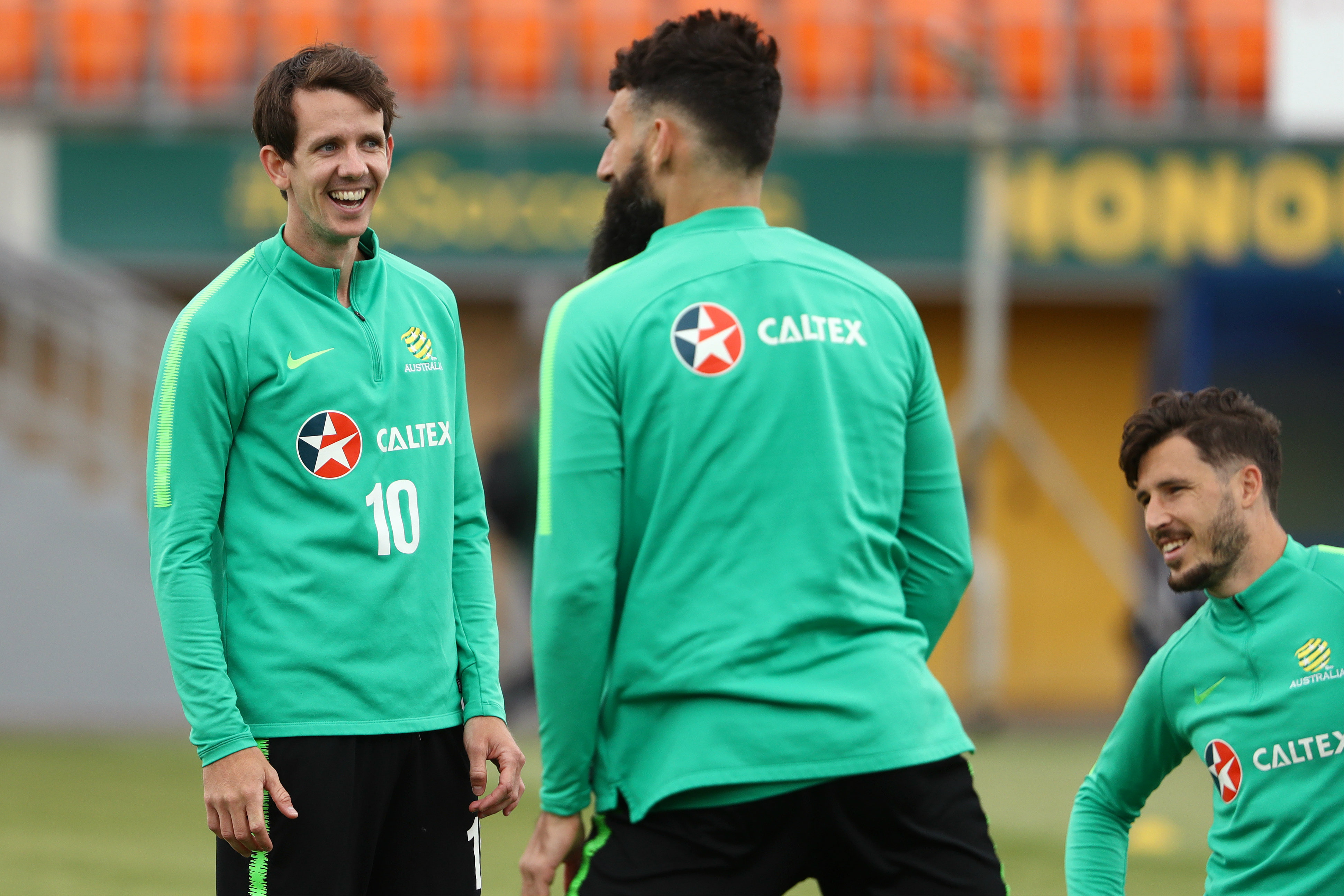 Robbie Kruse in training alongside Mathew Leckie and Mile Jedinak.