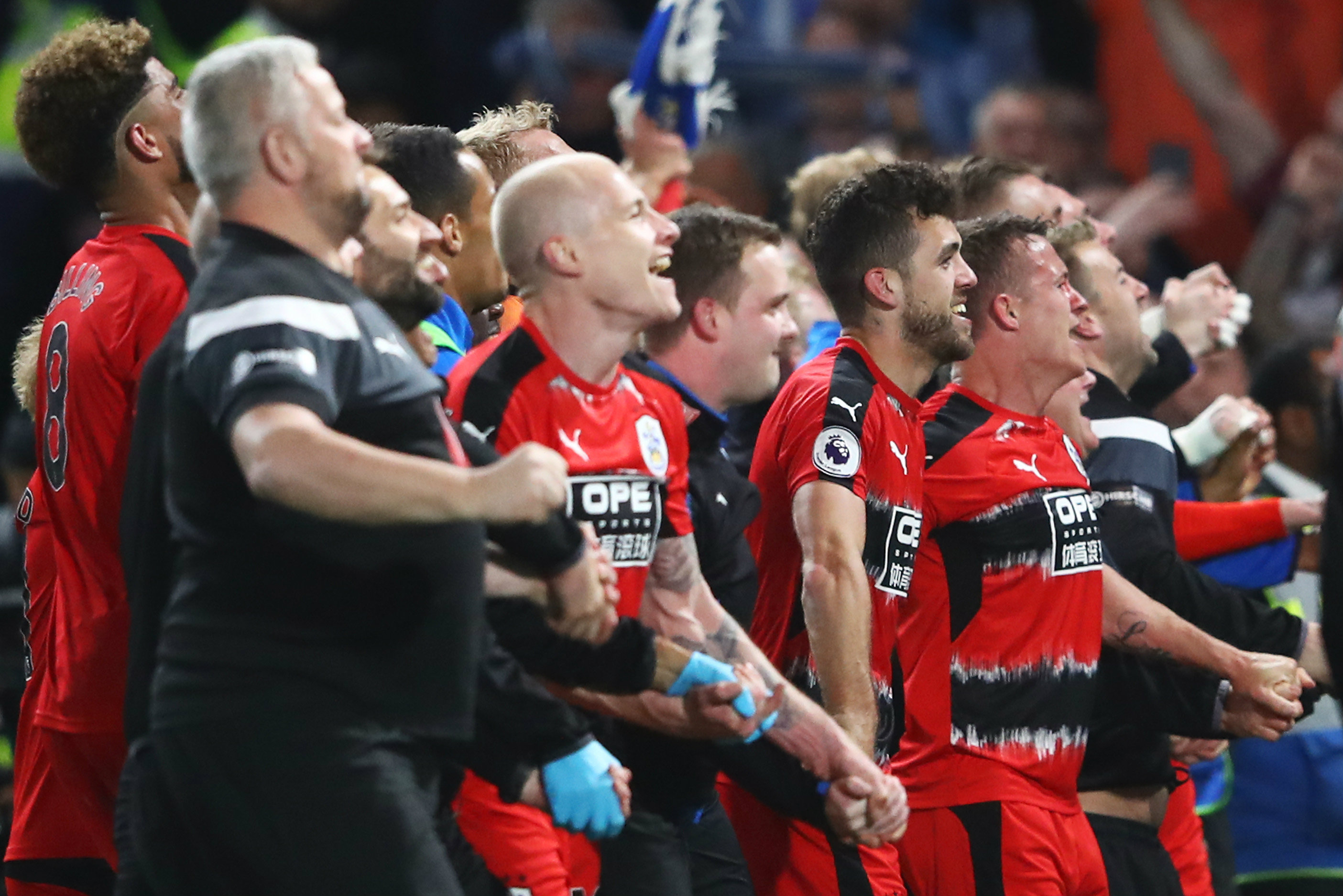 Aaron Mooy and his Huddersfield teammates celebrate avoiding relegation.