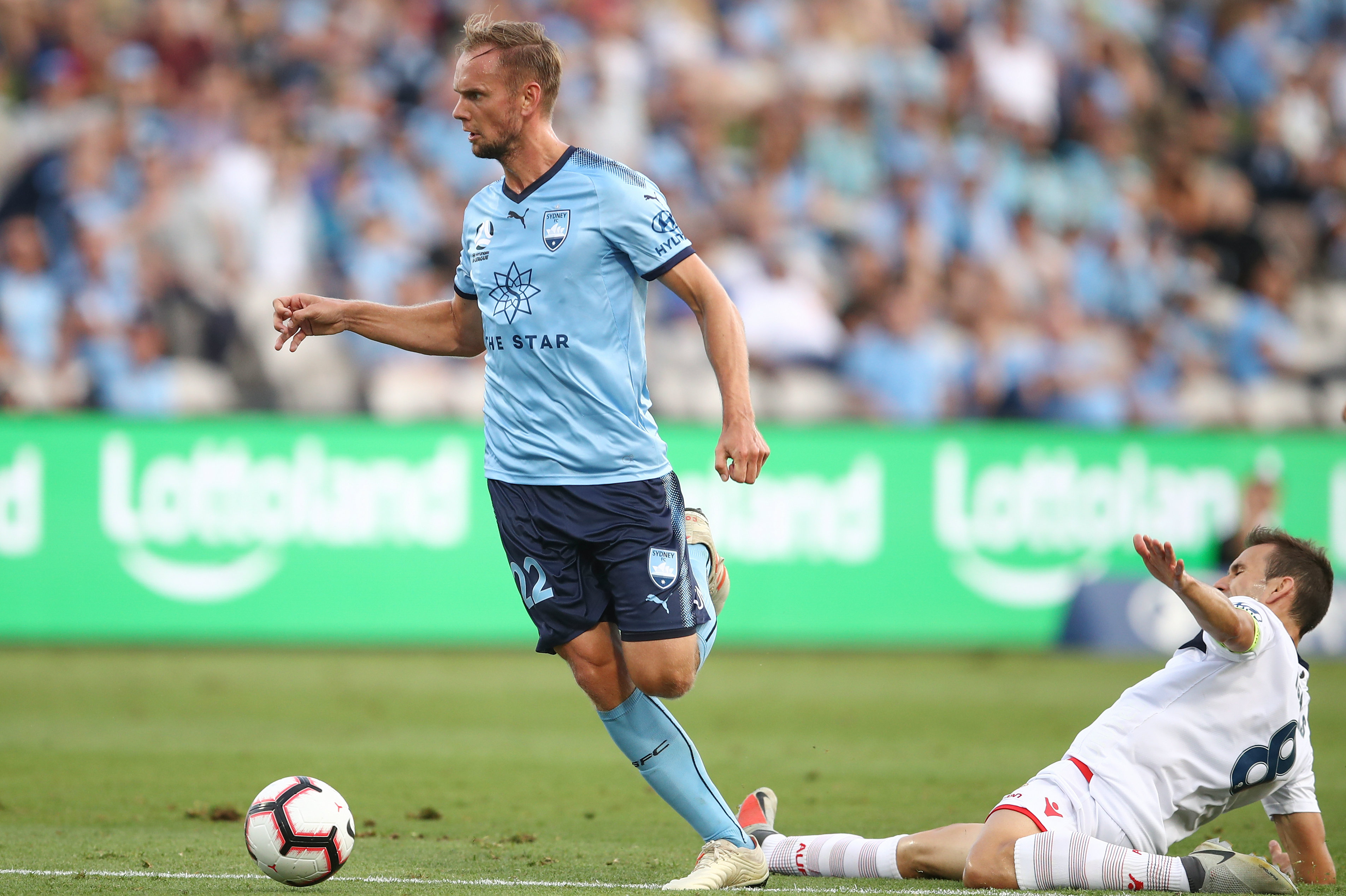 Siem de Jong skips away from a challenge from Adelaide skipper Isaias