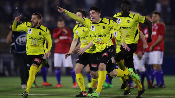 Heidelberg United players celebrate following their shootout win over Sydney United.