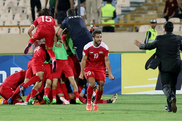 Syria players celebrate after securing a playoff spot to face the Caltex Socceroos.