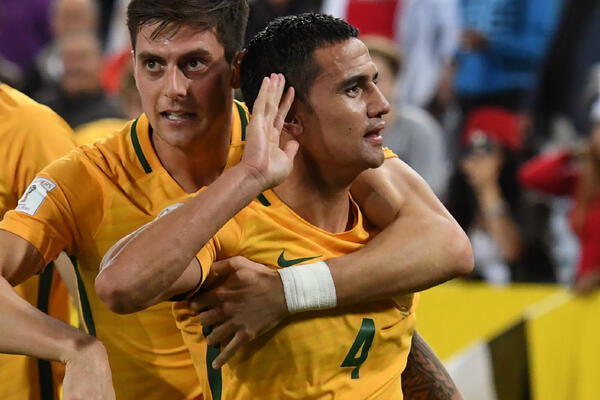 Tim Cahill is swamped after scoring the winner against Syria.