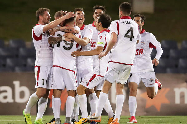 Adelaide United celebrate a goal.