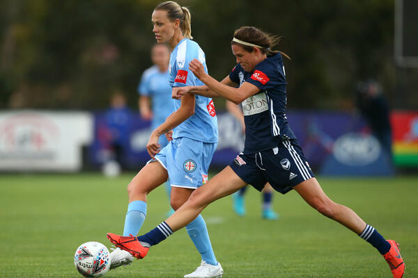 Victory's Emily Menges puts pressure on Emily van Egmond in the derby