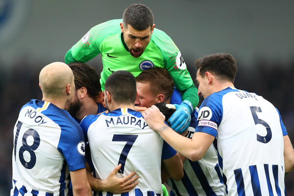 Maty Ryan and Aaron Mooy celebrate Brighton's first goal with teammates