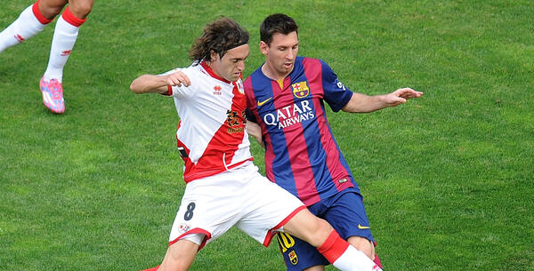 Raul Baena tackles Lionel Messi while playing for Granada CF