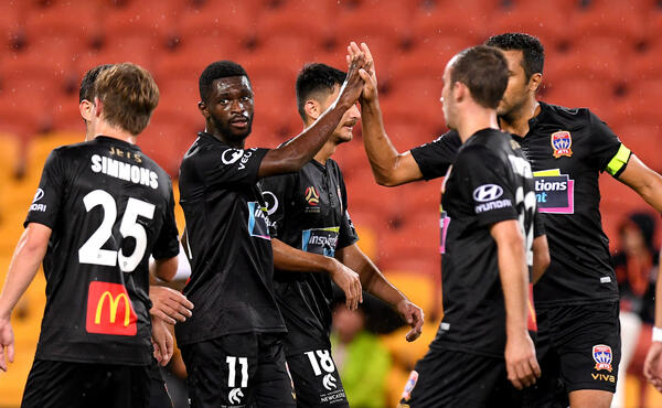 Kwabena Appiah-Kubi celebrates with Newcastle Jets team-mates