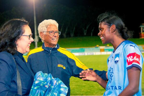 Evans greets her mentor John Moriarty, the first recognised Indigenous Australian to be selected for the national football team