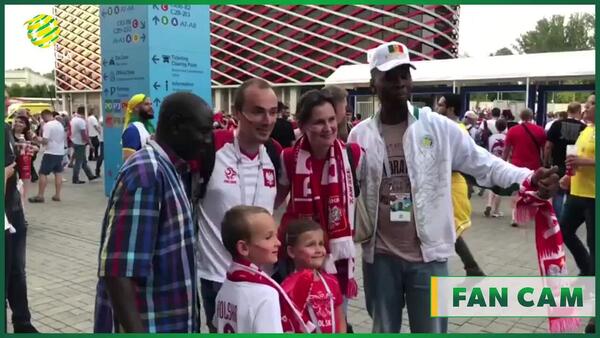 Senegalese and Polish fans take photos together post game