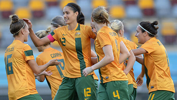 Kate Gill celebrates with teammates after scoring for the Matildas against Brazil in a friendly.