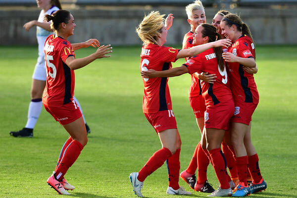 Adelaide United celebrate a goal.
