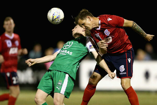 Michael Jakobsen wins a header against his Bentleigh opponent.