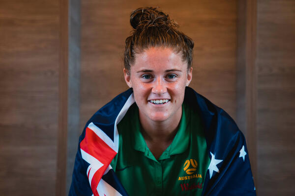 Teagan Micah gets her portrait shot taken with the Australian flag