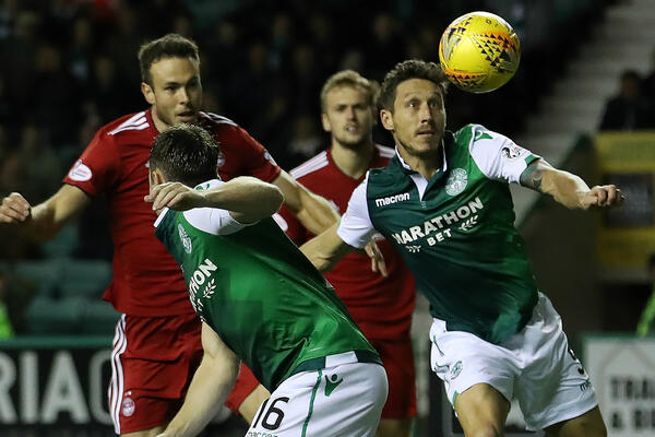 Mark Milligan in action for Hibernian.