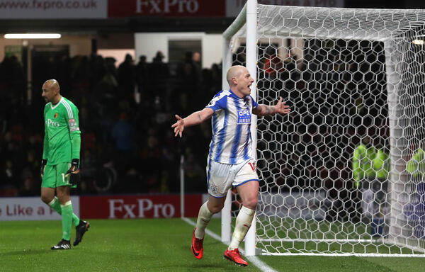 Aaron Mooy celebrates after converting a late penalty for Huddersfield.