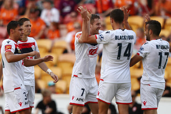 Adelaide United players celebrate a goal