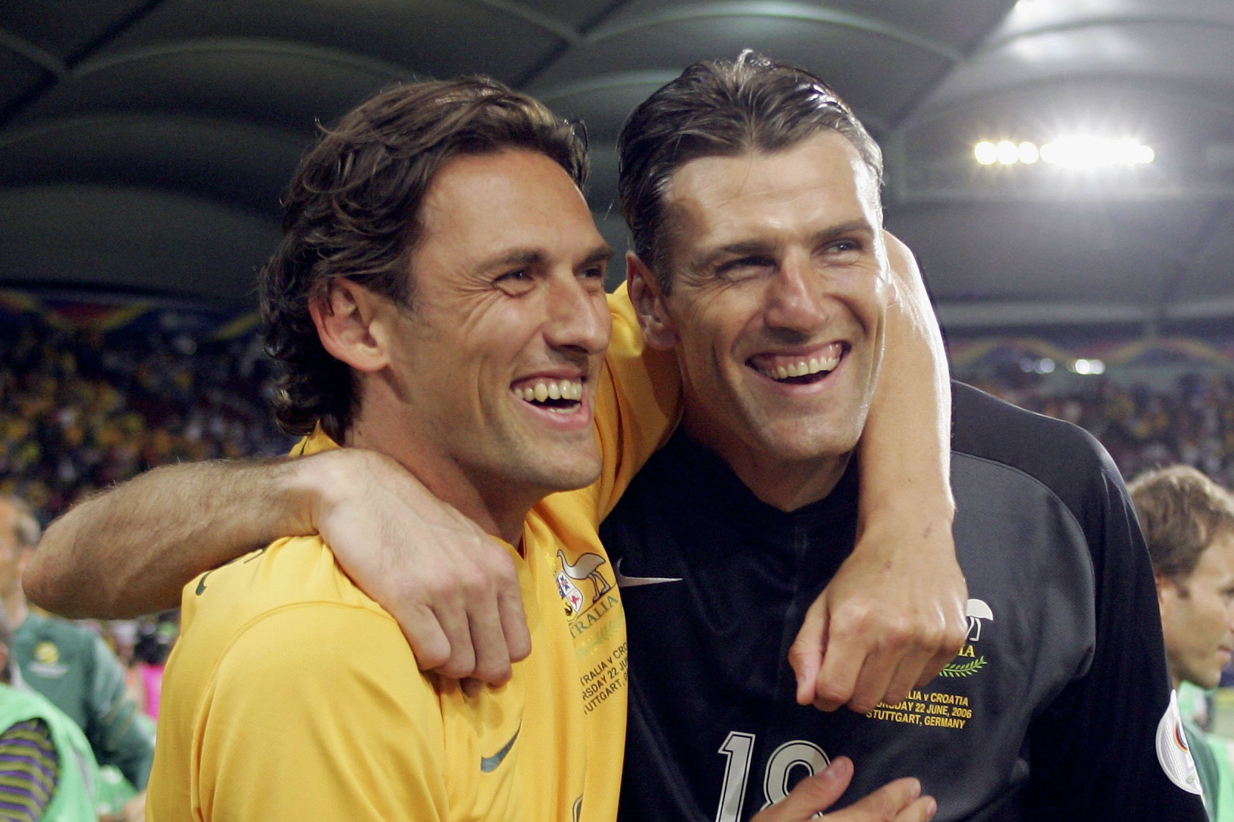 Tony Popovic and Zeljko Kalac celebrate after the draw against Croatia.